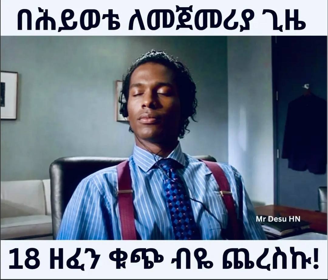 a man in a blue shirt and tie sitting in a chair